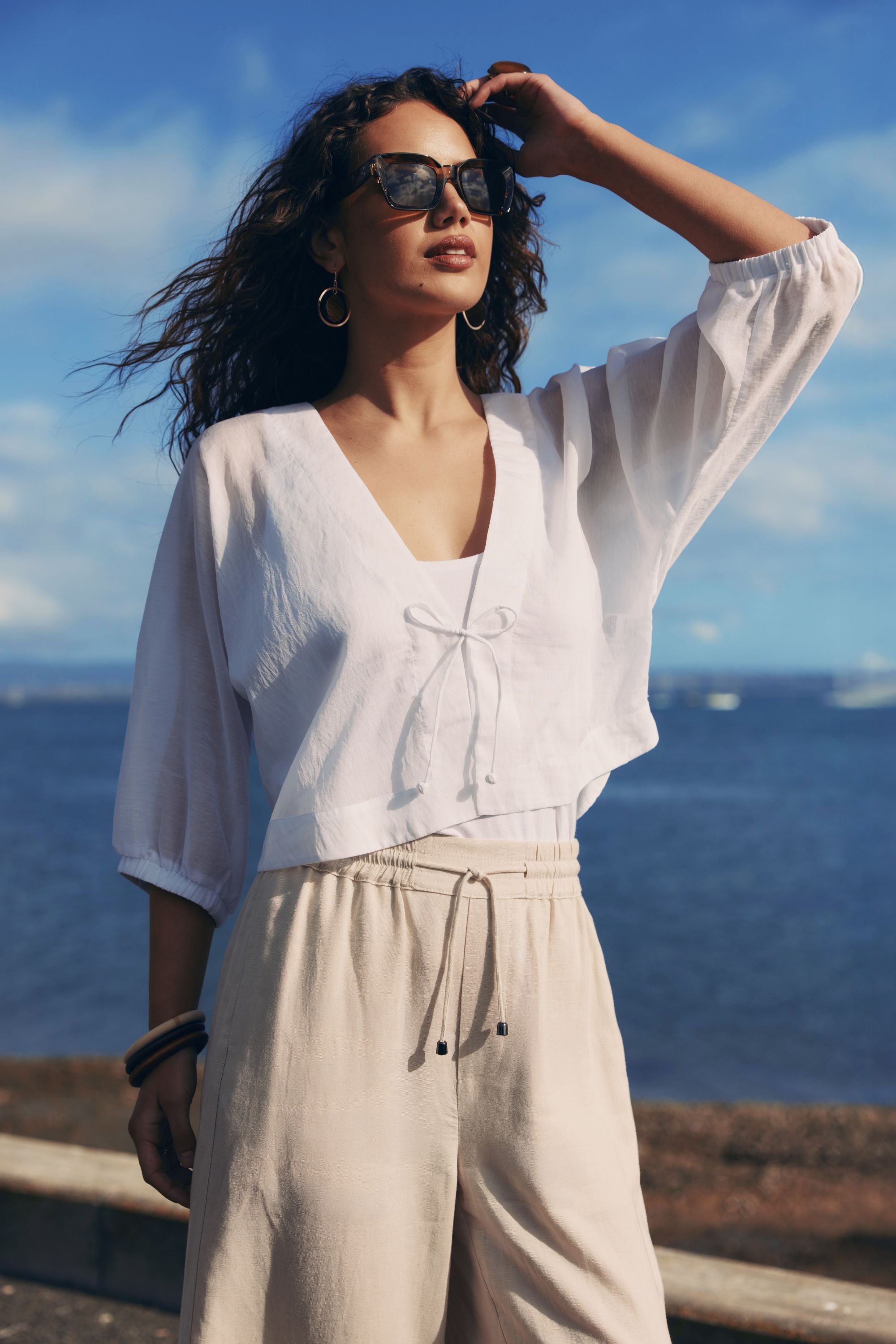 white tie jacket worn by model with ocean background