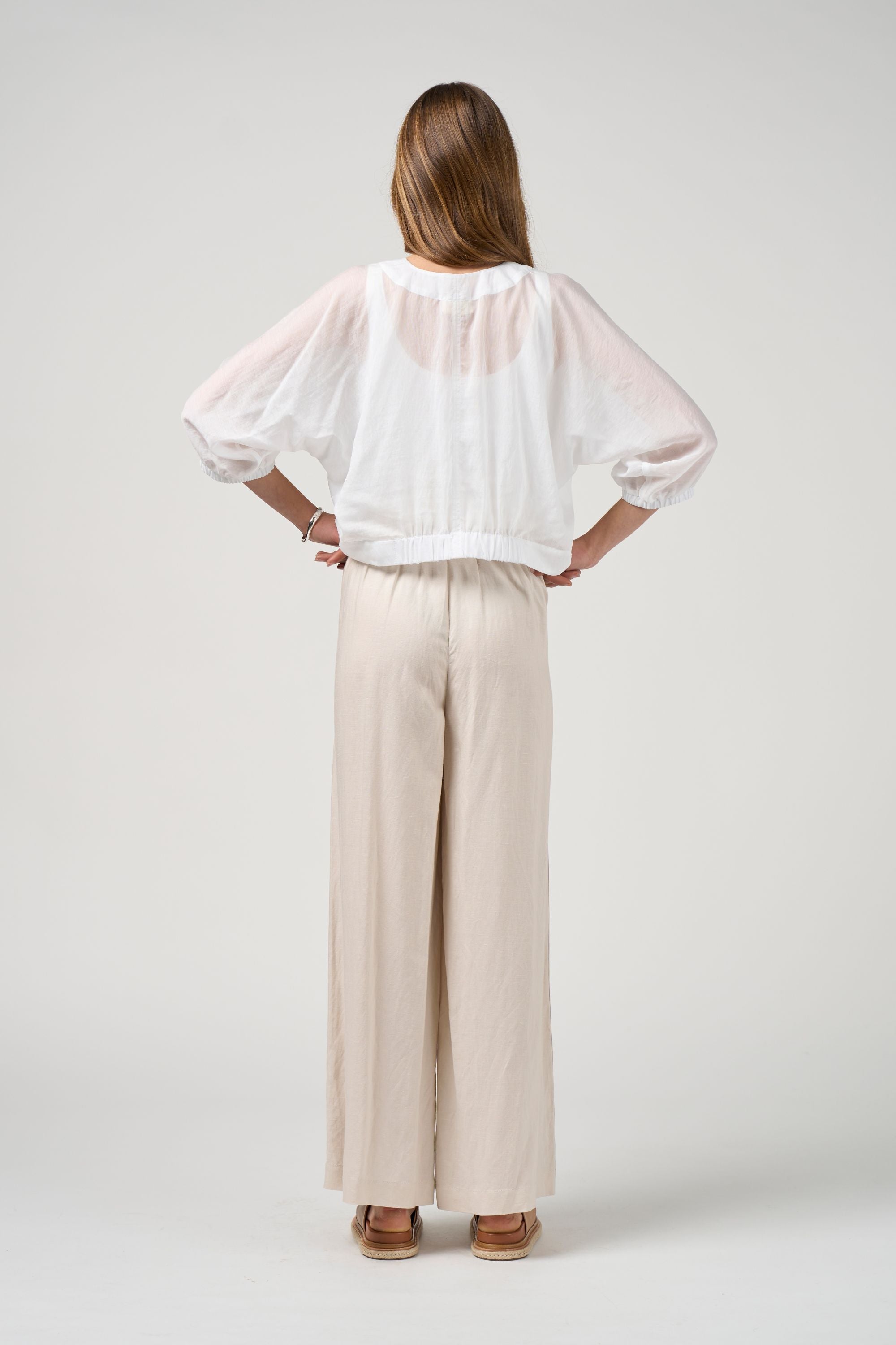 white tie jacket with white pant worn by model back view