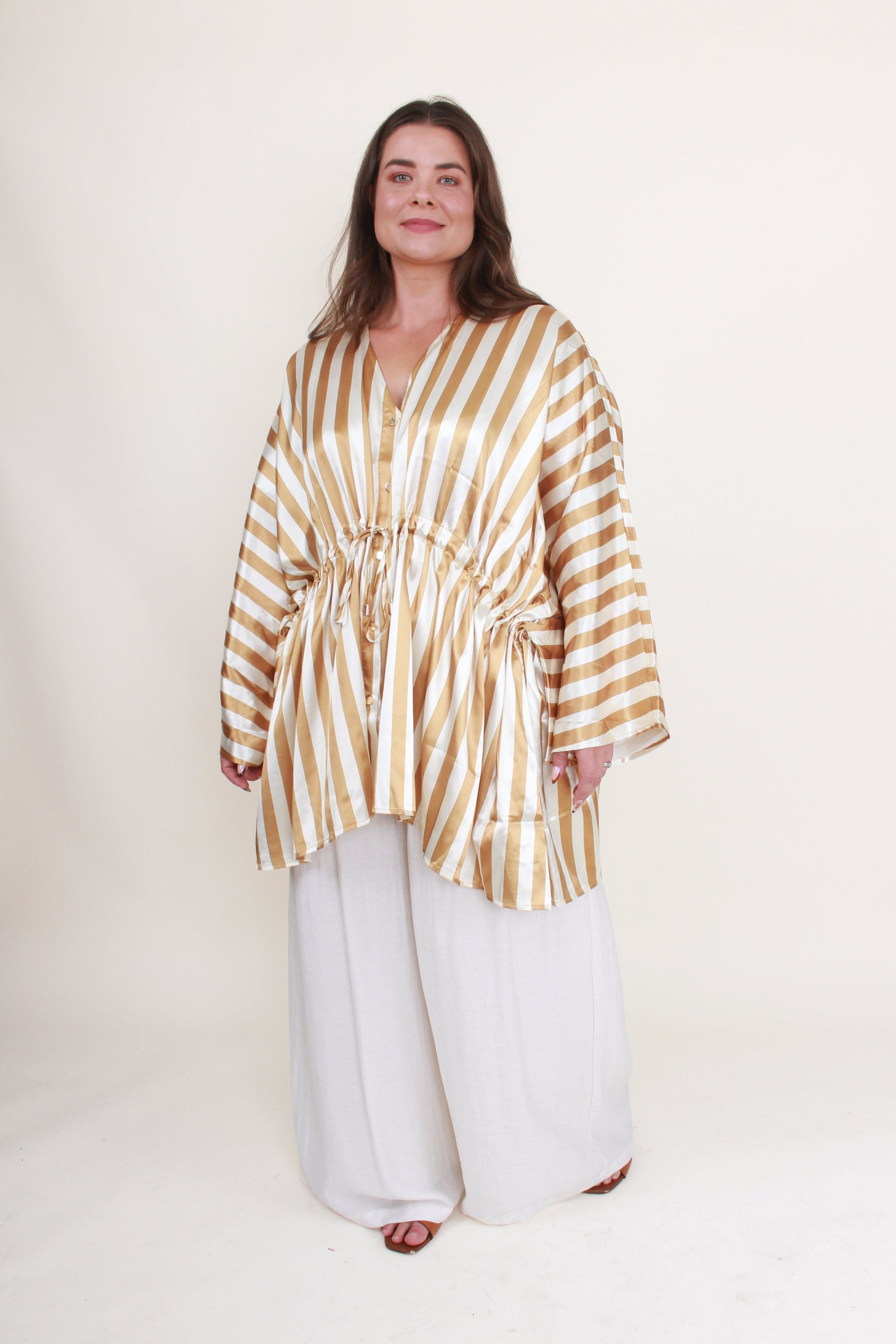 cream and gold satin stripe kimono  and white pant worn by model