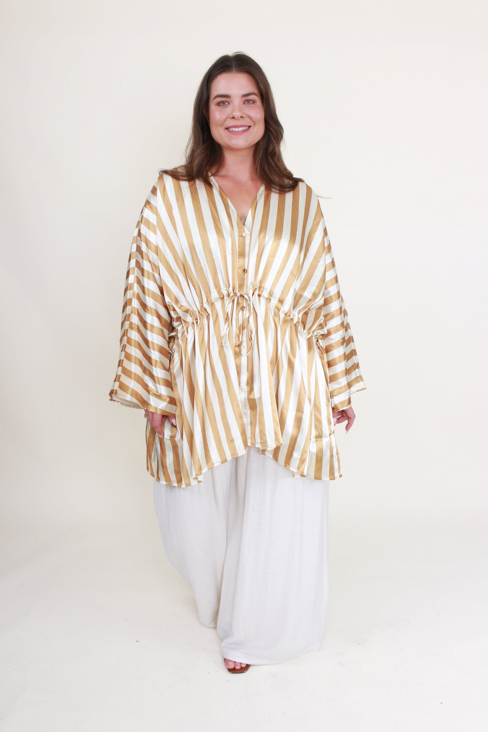 cream and gold satin stripe kimono  and white pant worn by model