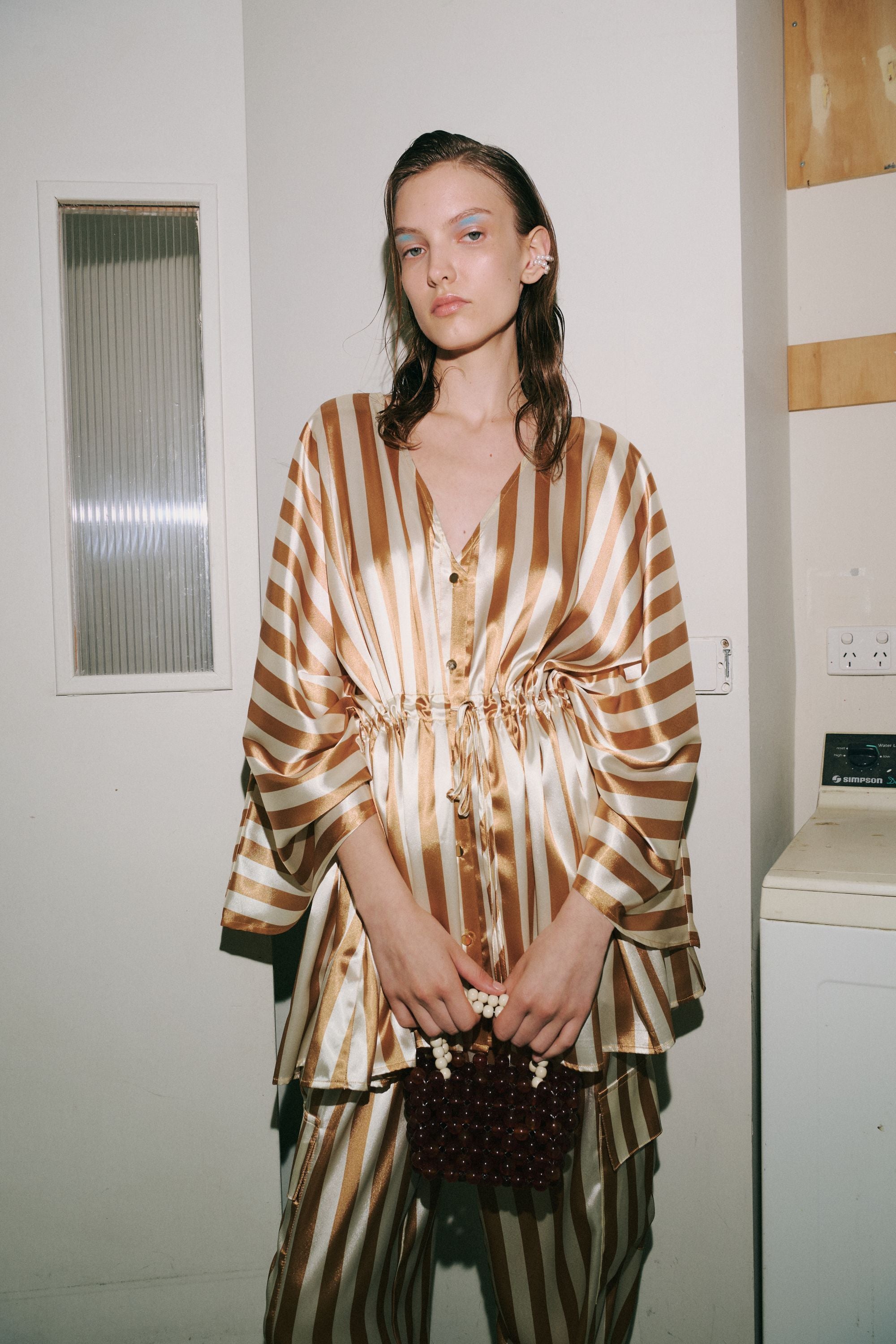 cream and gold satin stripe kimono worn by model 