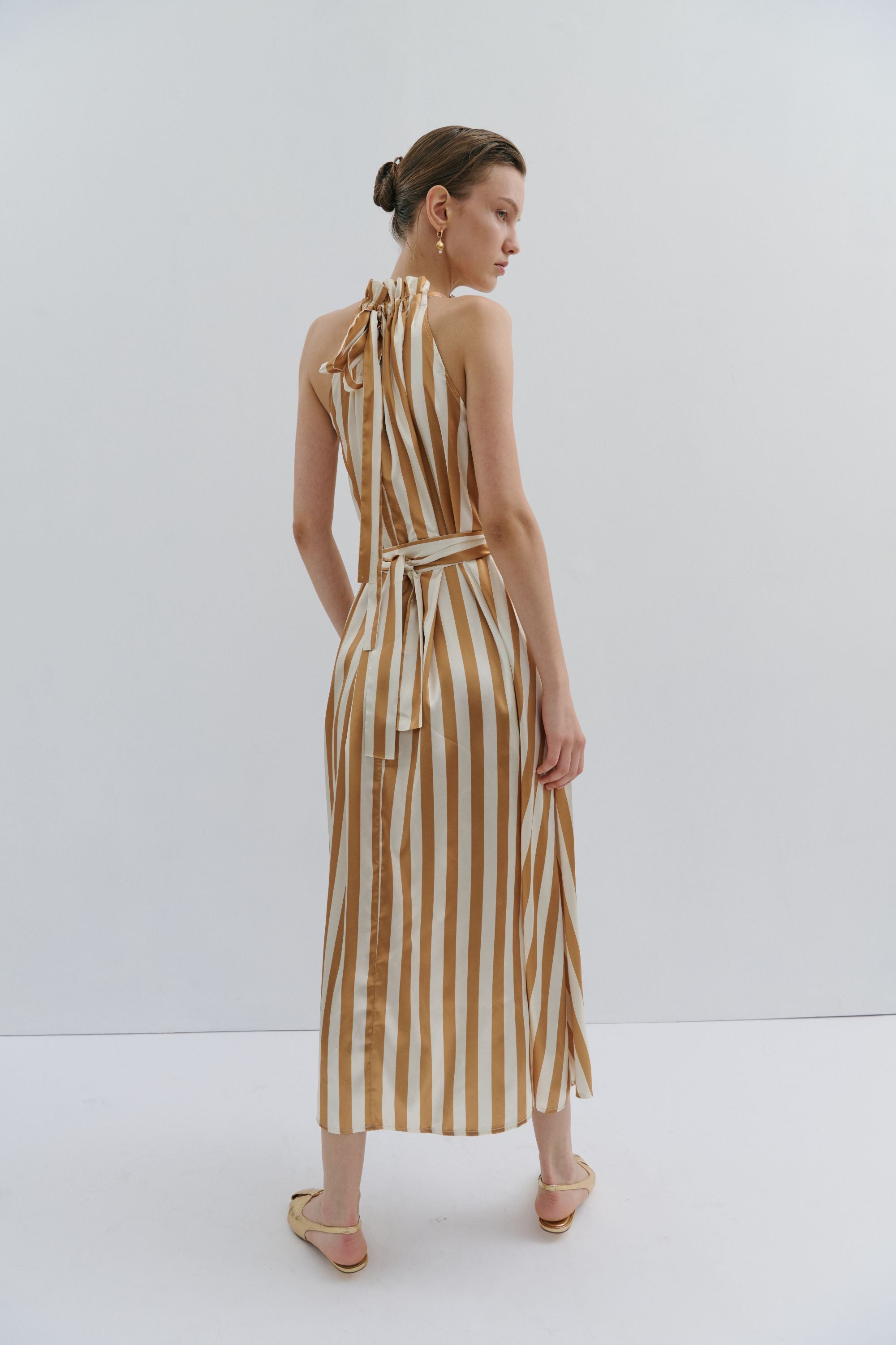 maxi dress gold and cream pinstripe worn by model back