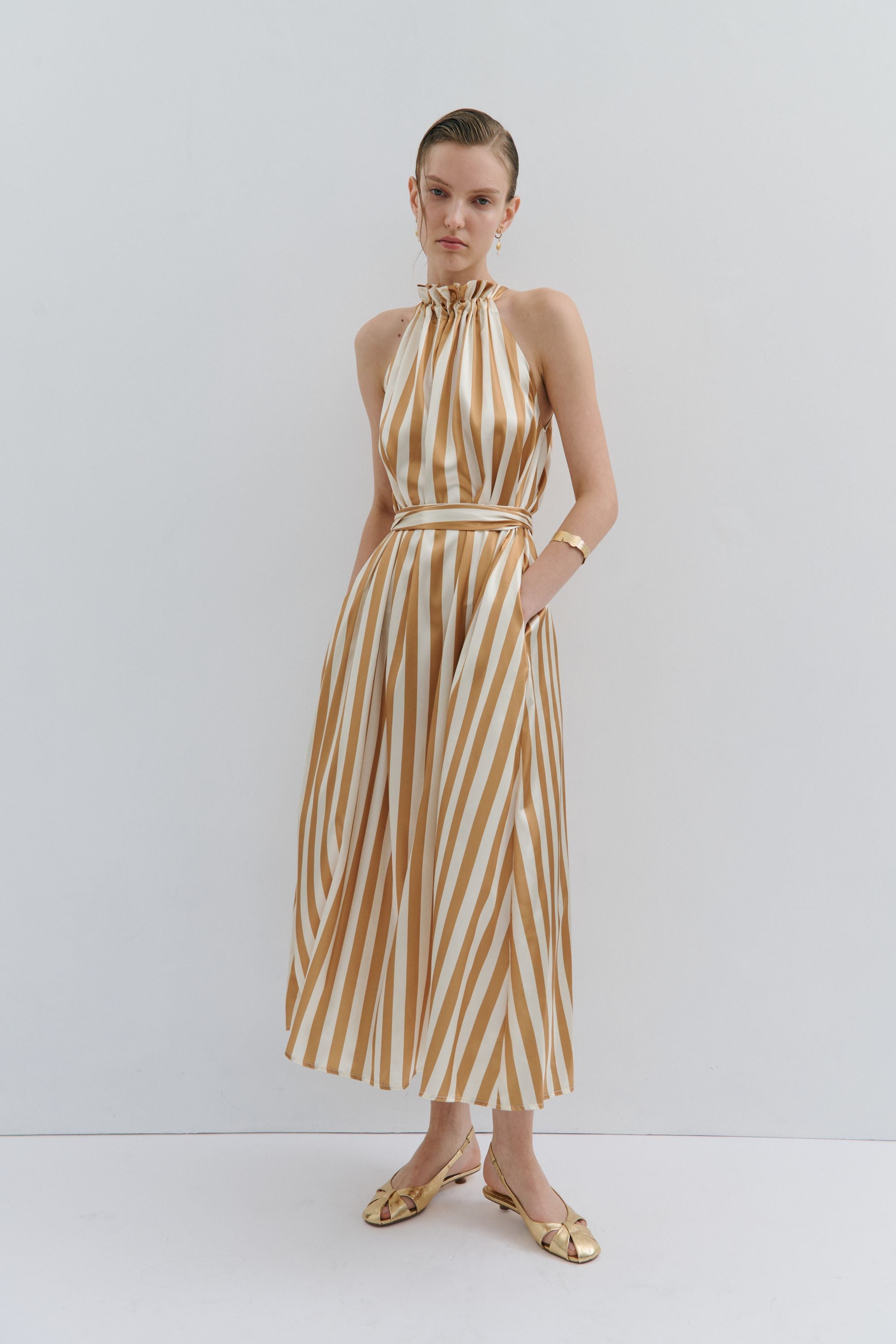 maxi dress gold and cream pinstripe worn by model 
