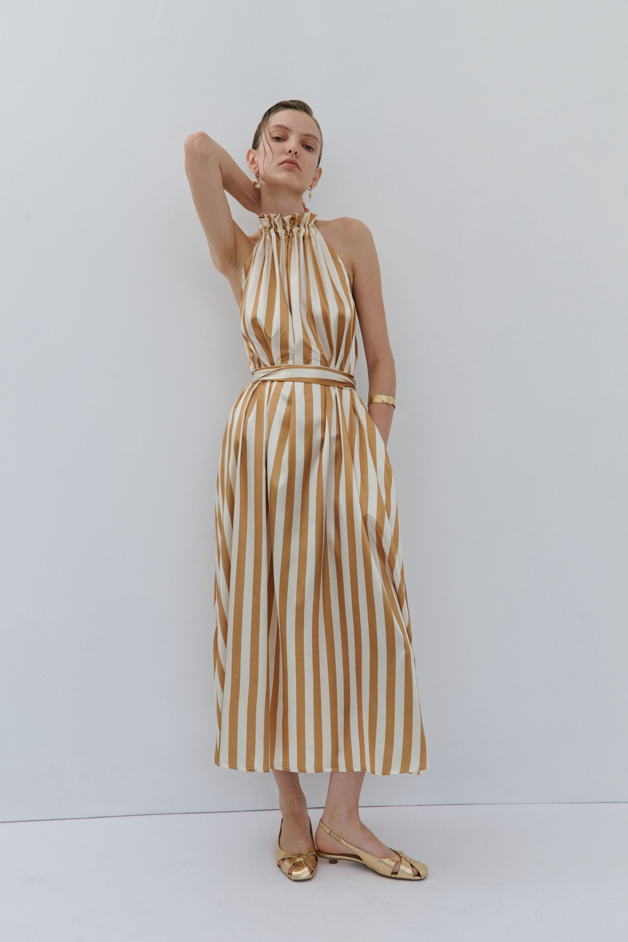 maxi dress gold and cream pinstripe worn by model 