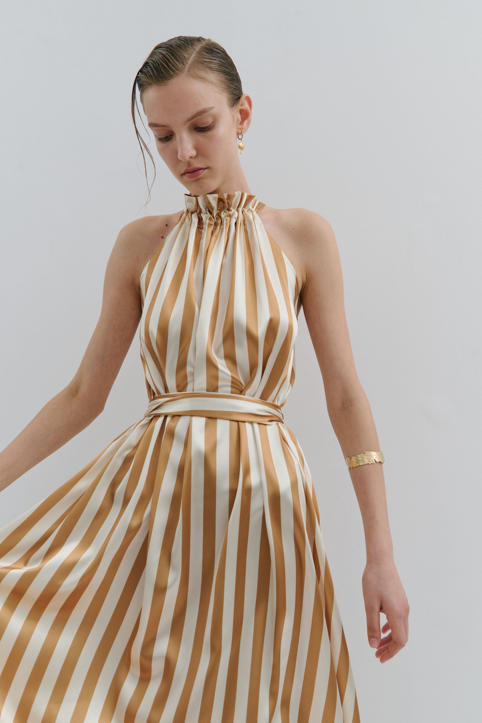 maxi dress gold and cream pinstripe worn by model 