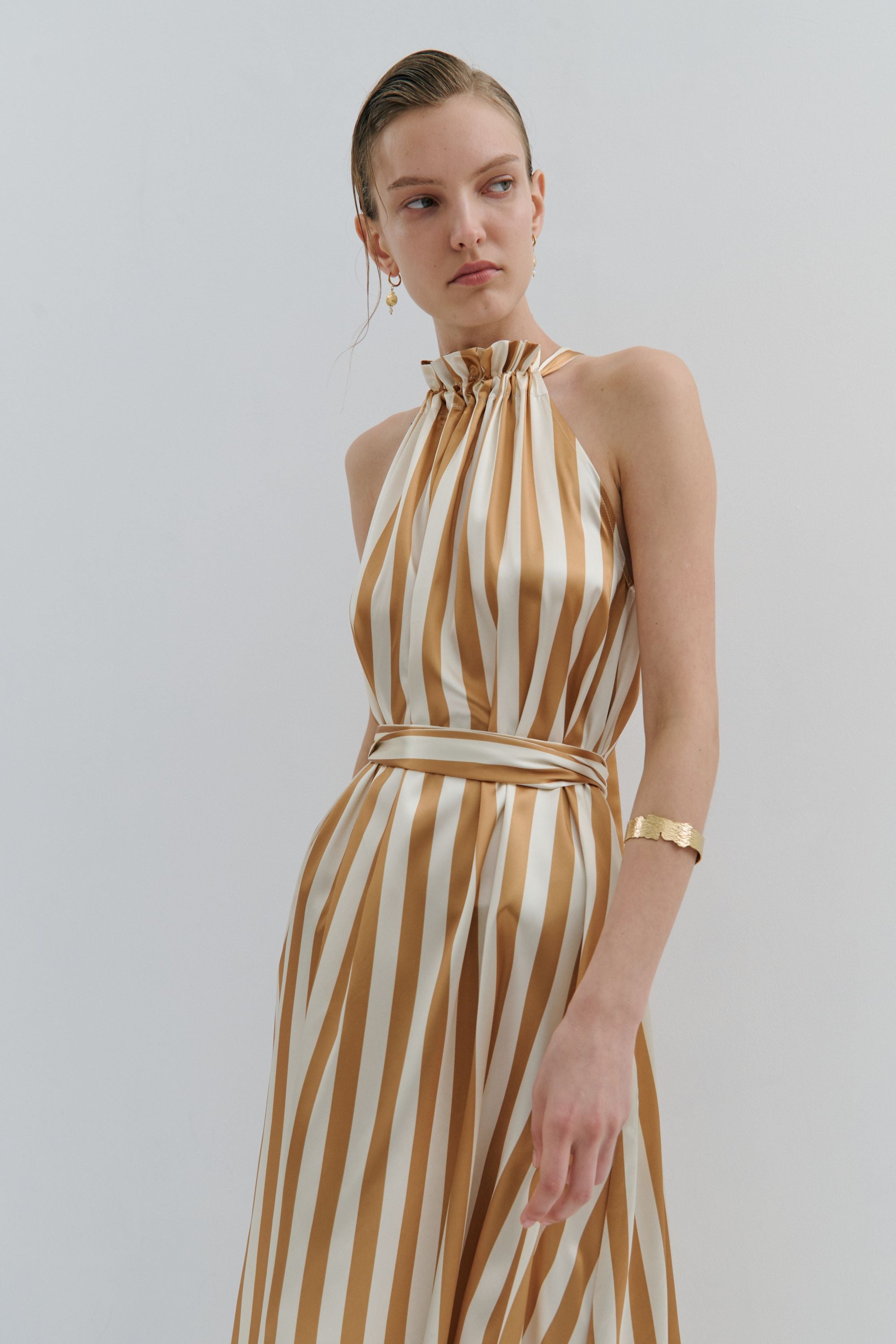 maxi dress gold and cream pinstripe worn by model 