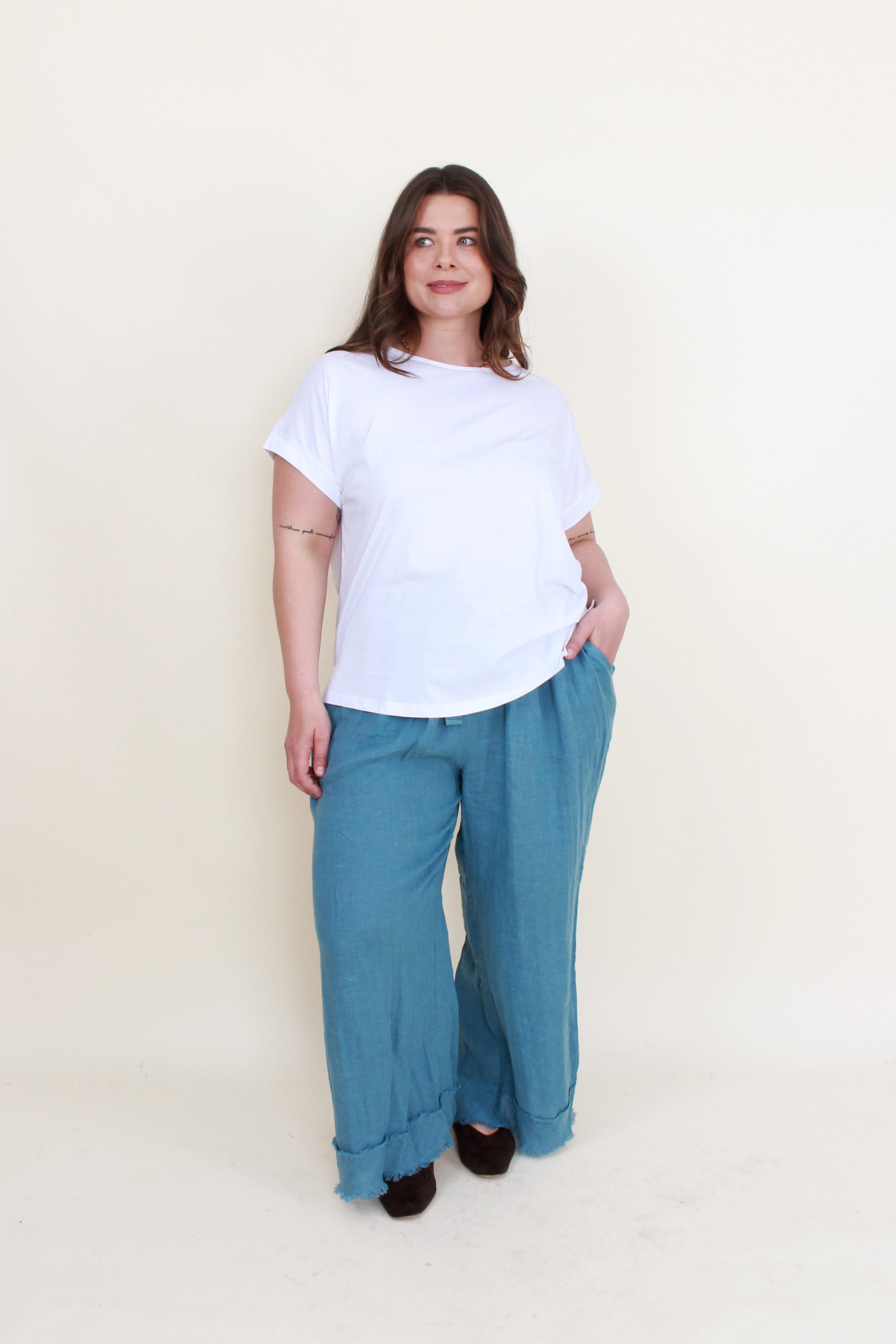 blue frey hem pants white top worn by model 