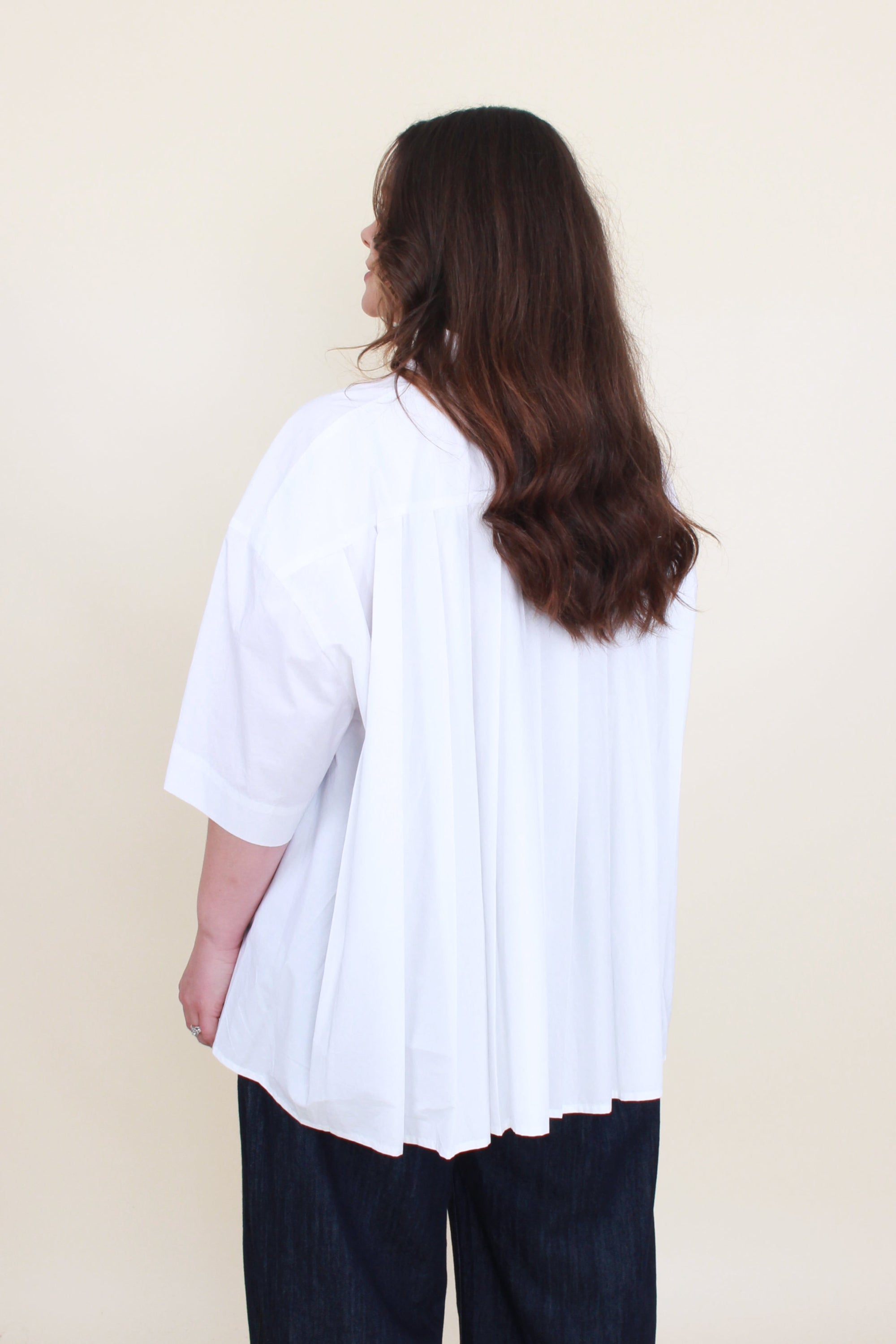 womens boxy shirt in white with back pleating worn by model back view