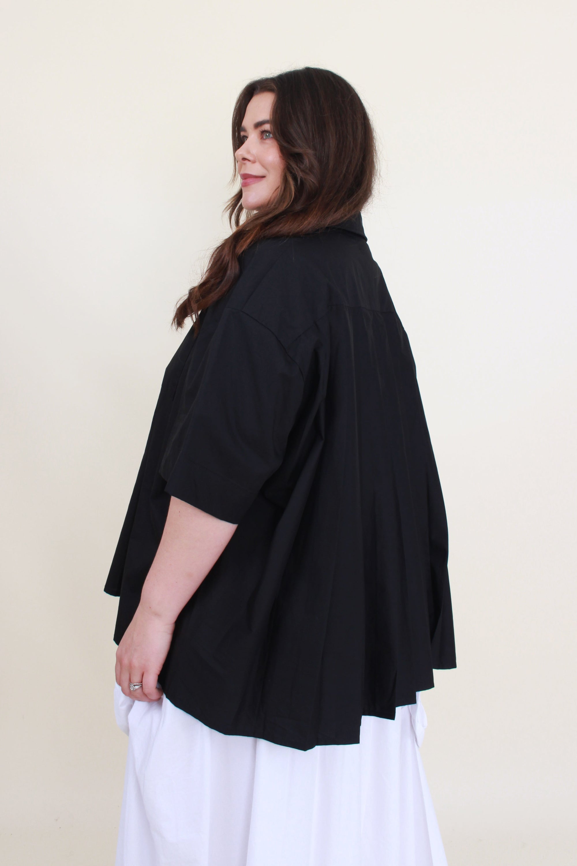 womens boxy shirt in black with pleats worn by model