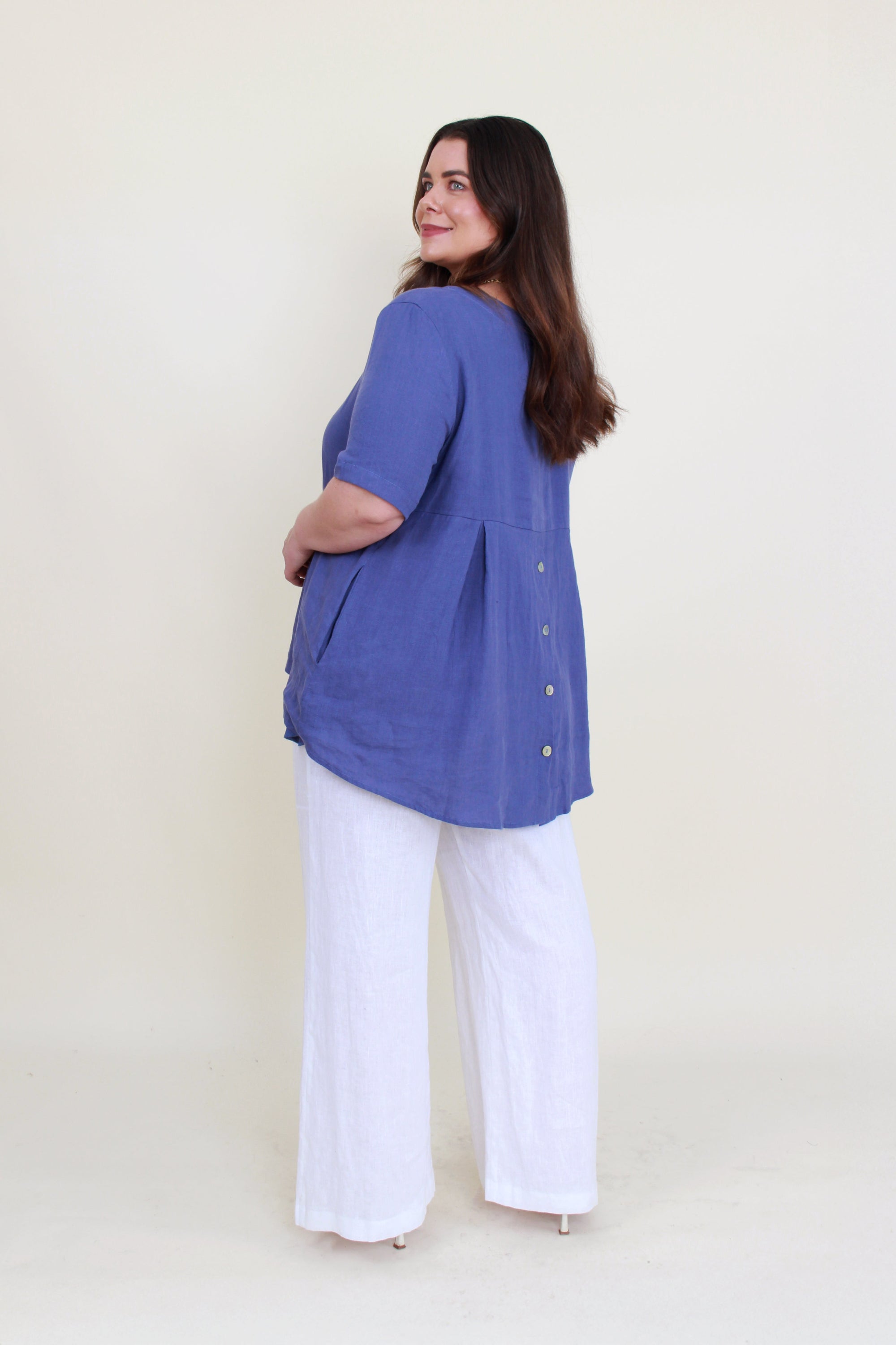 women curve hem linen top in denim worn by model back view