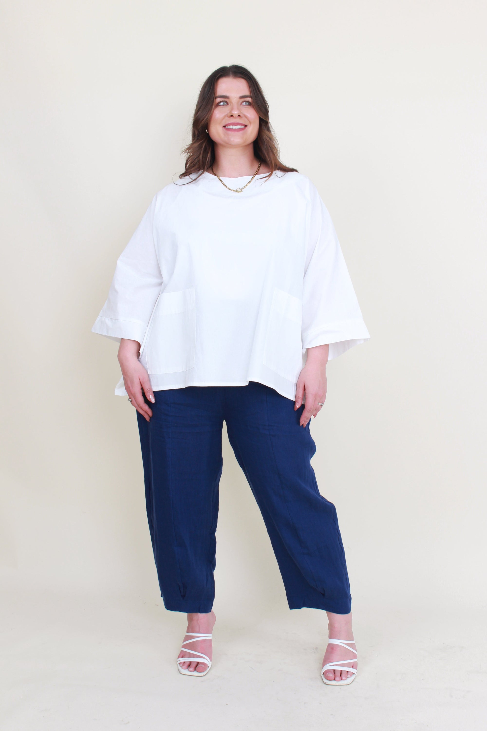 womens boxy patch pocket top in white with navy pant worn by model 
