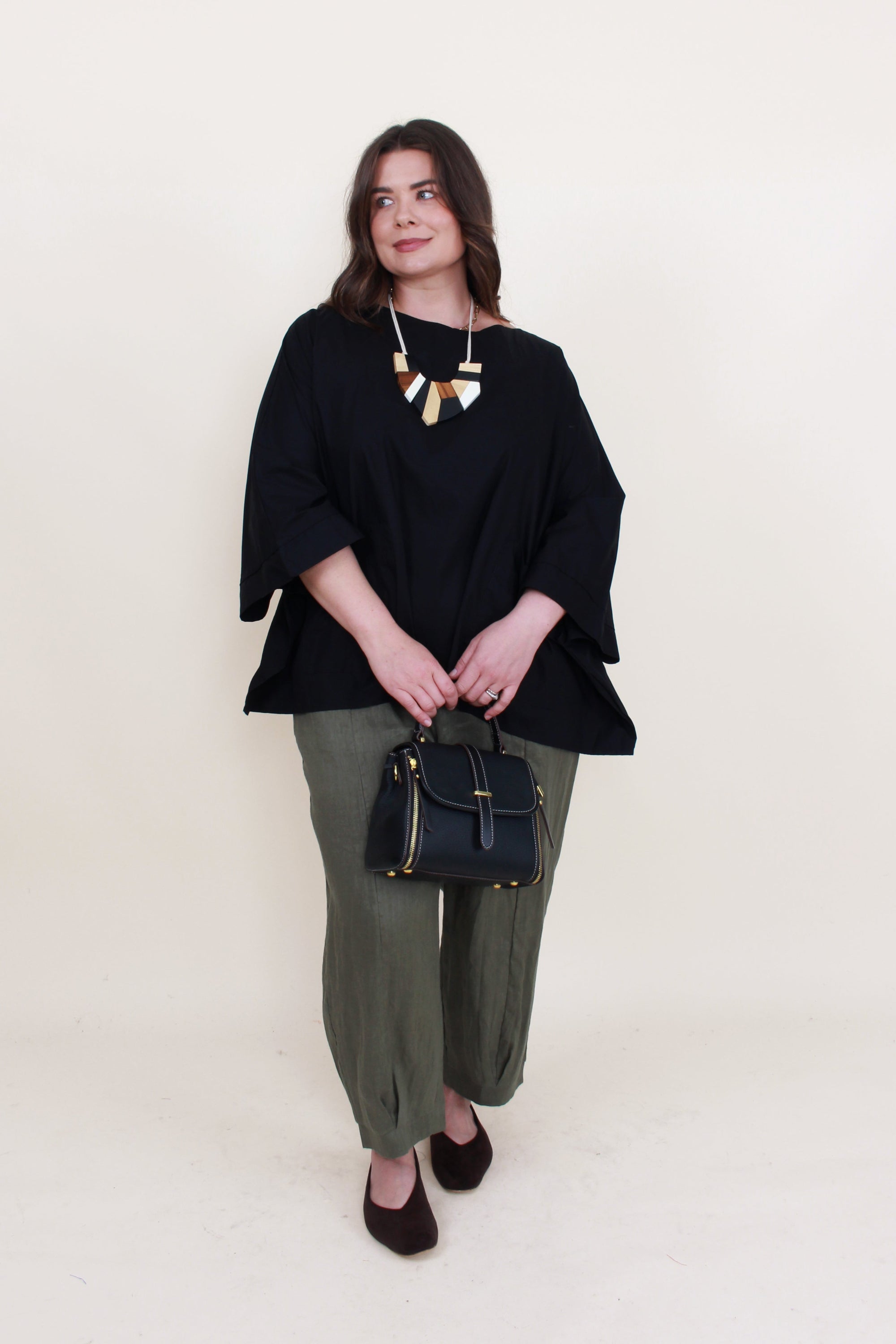 womens boxy patch pocket top in black with khaki pant worn by model 