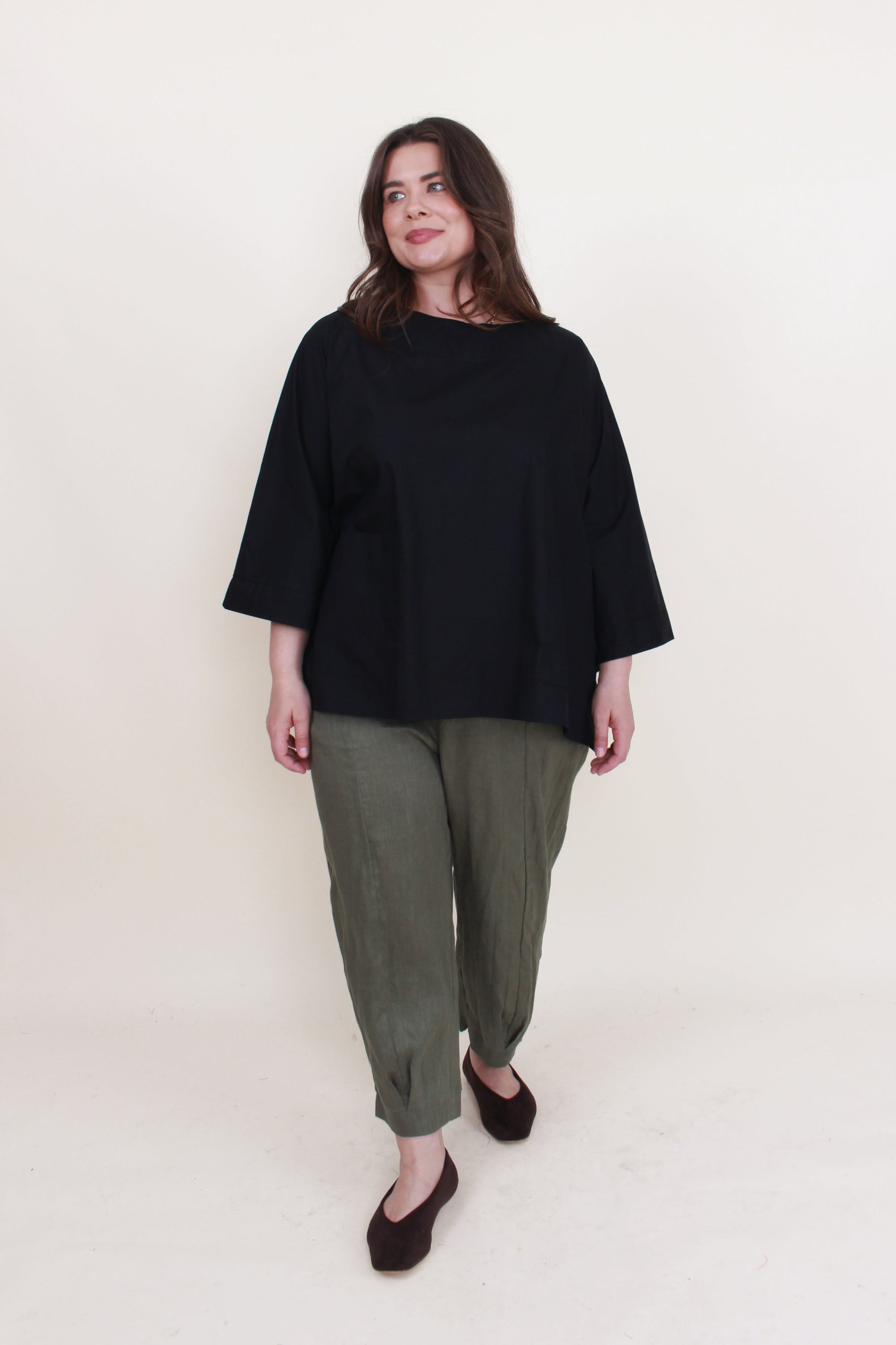 womens boxy patch pocket top in black with khaki pant worn by model 