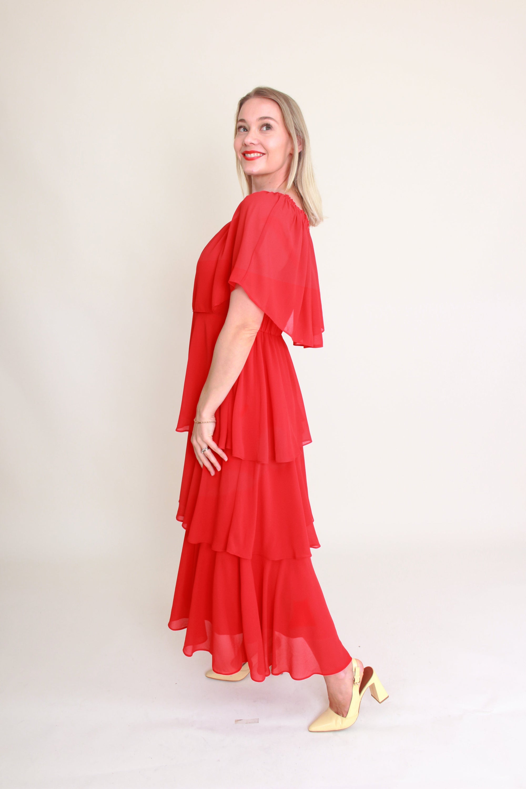 Woman wearing a red dress with a plain background