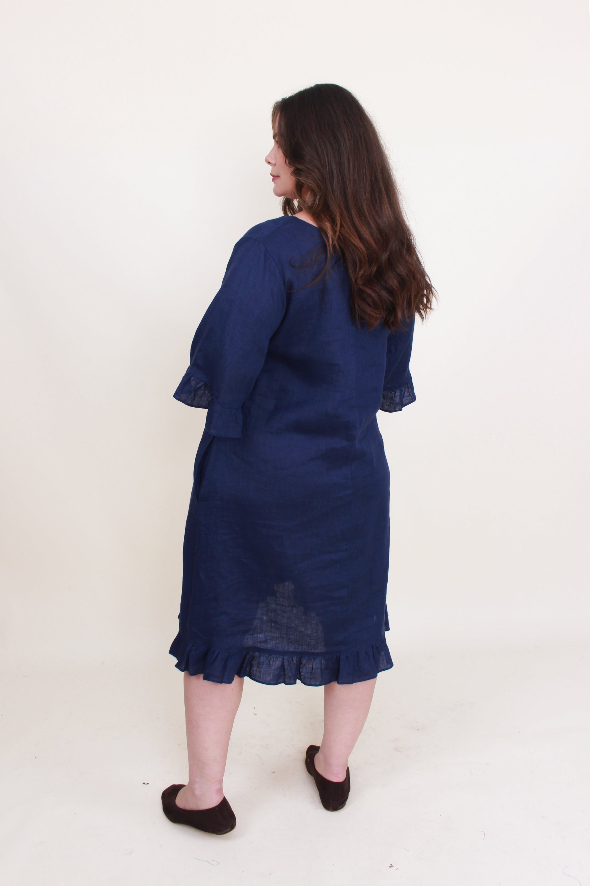 navy ruffle hem linen midi dress worn by model back view
