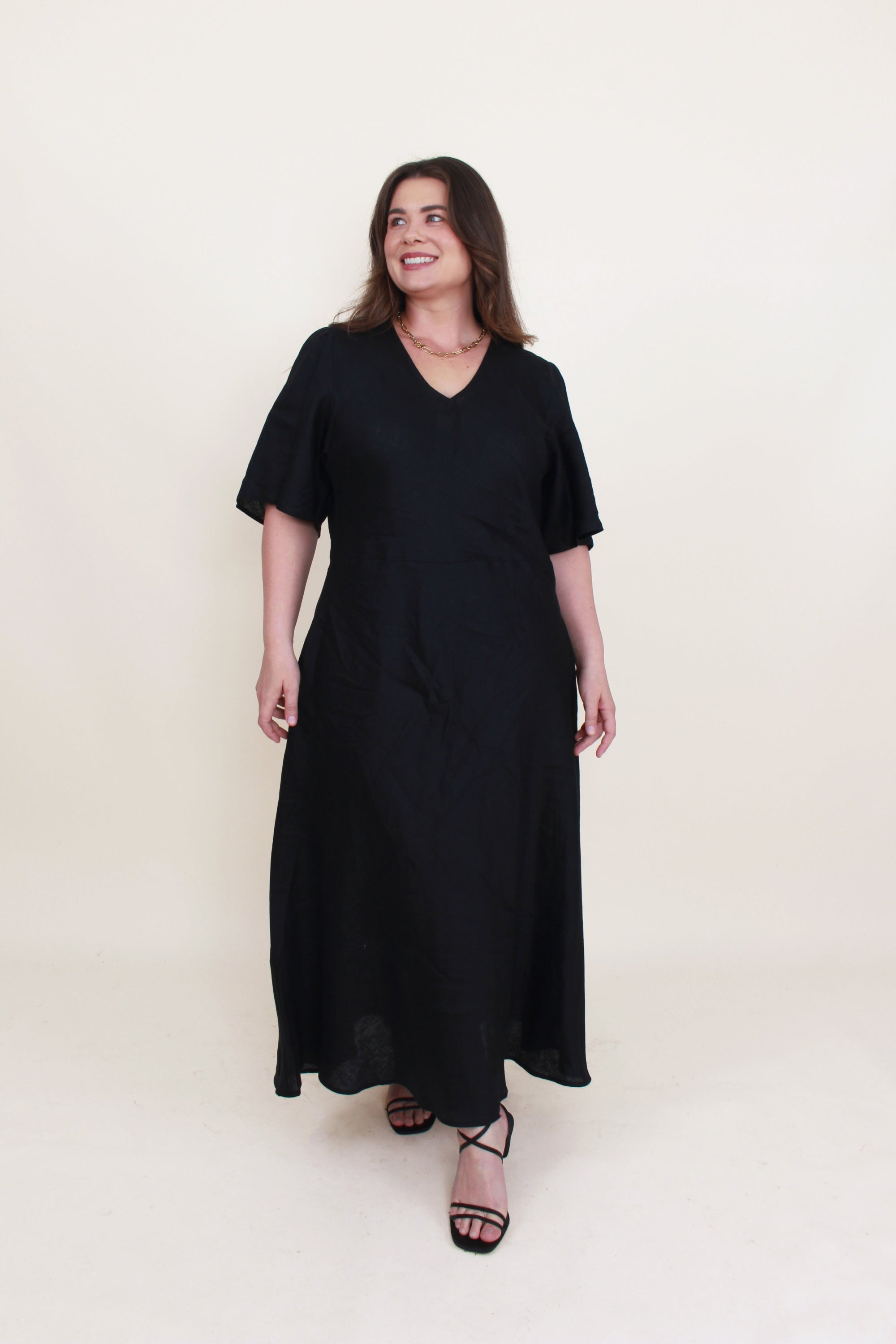 bias cut midi dress black worn by model 