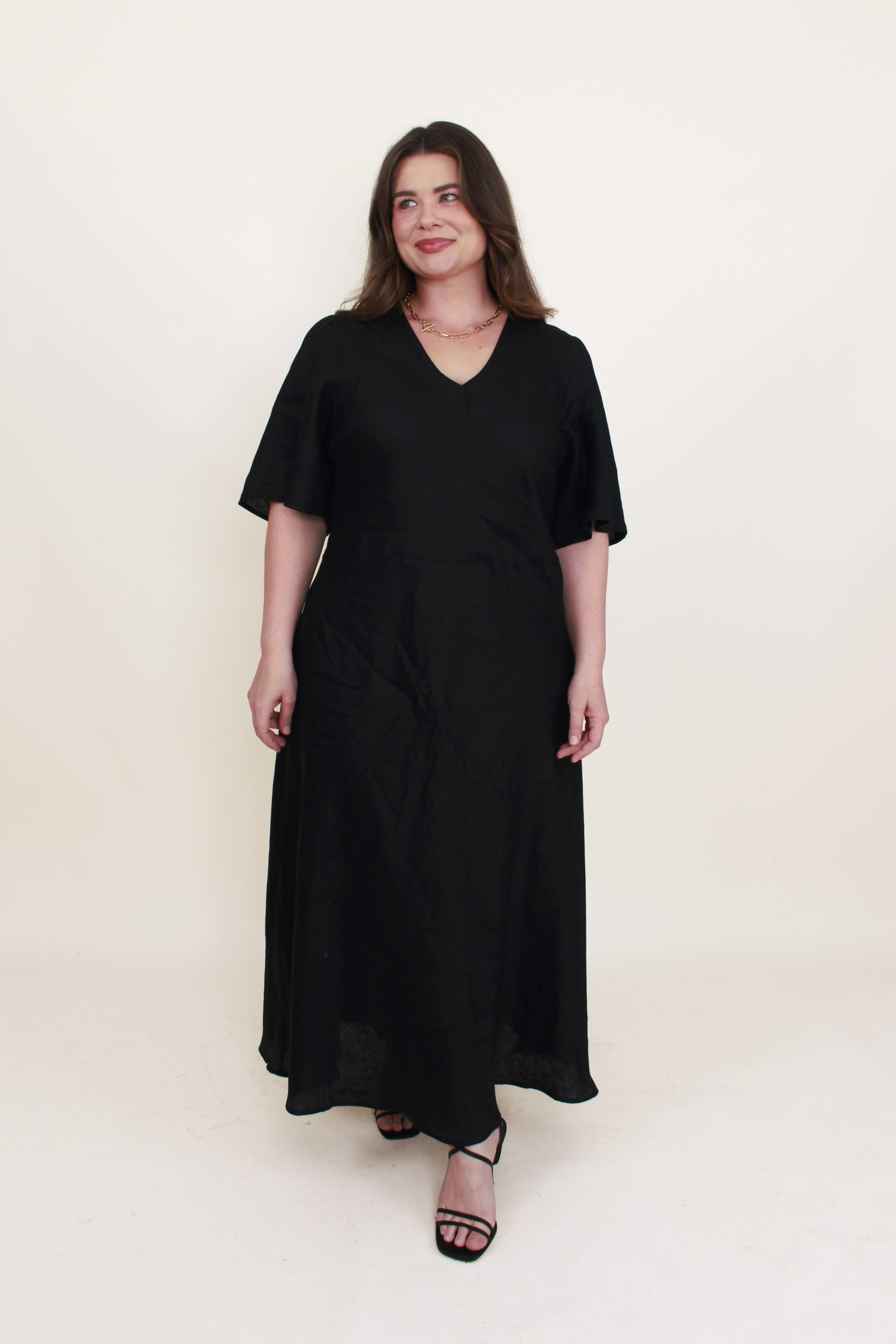 bias cut midi dress black worn by model 
