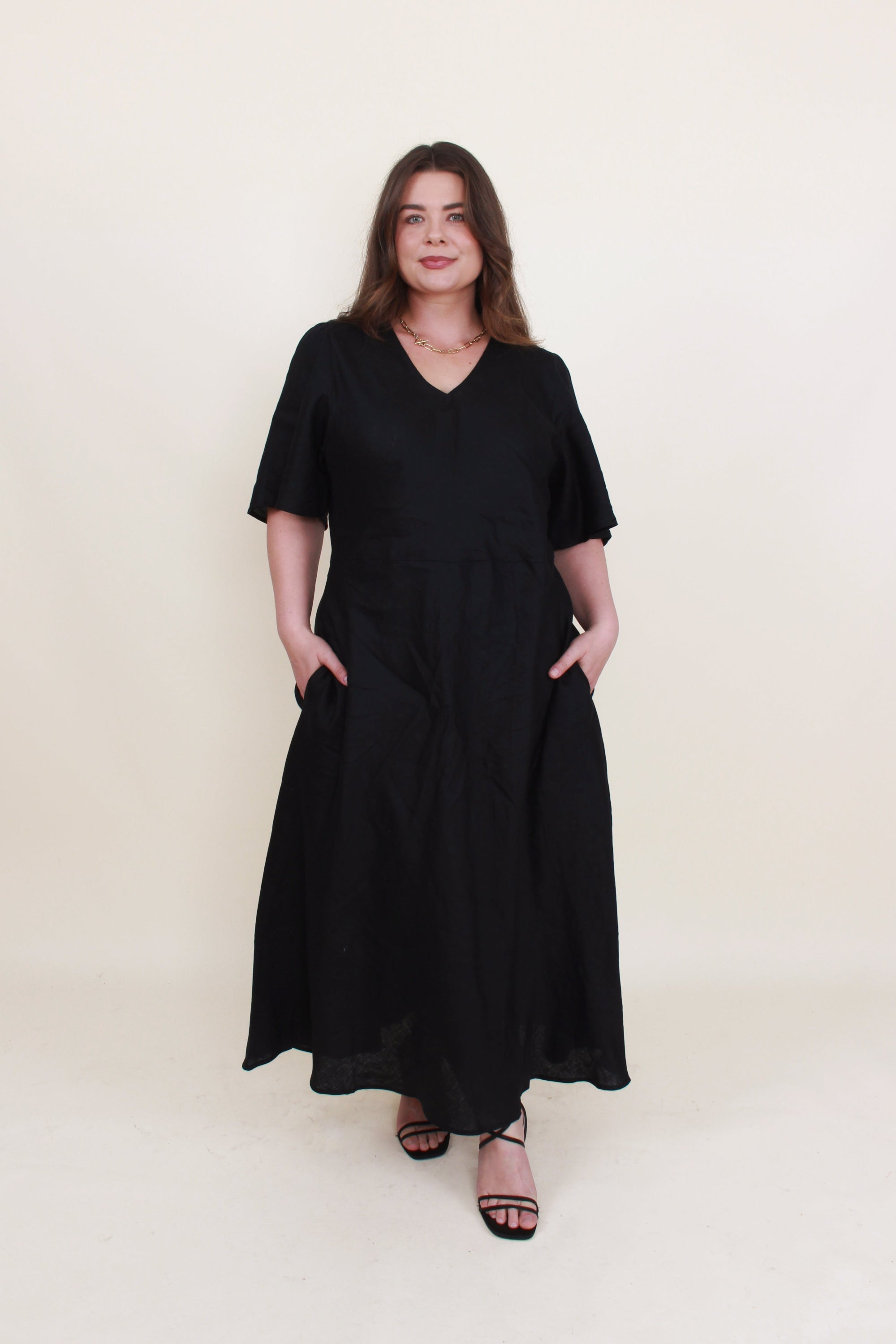 bias cut midi dress black worn by model 