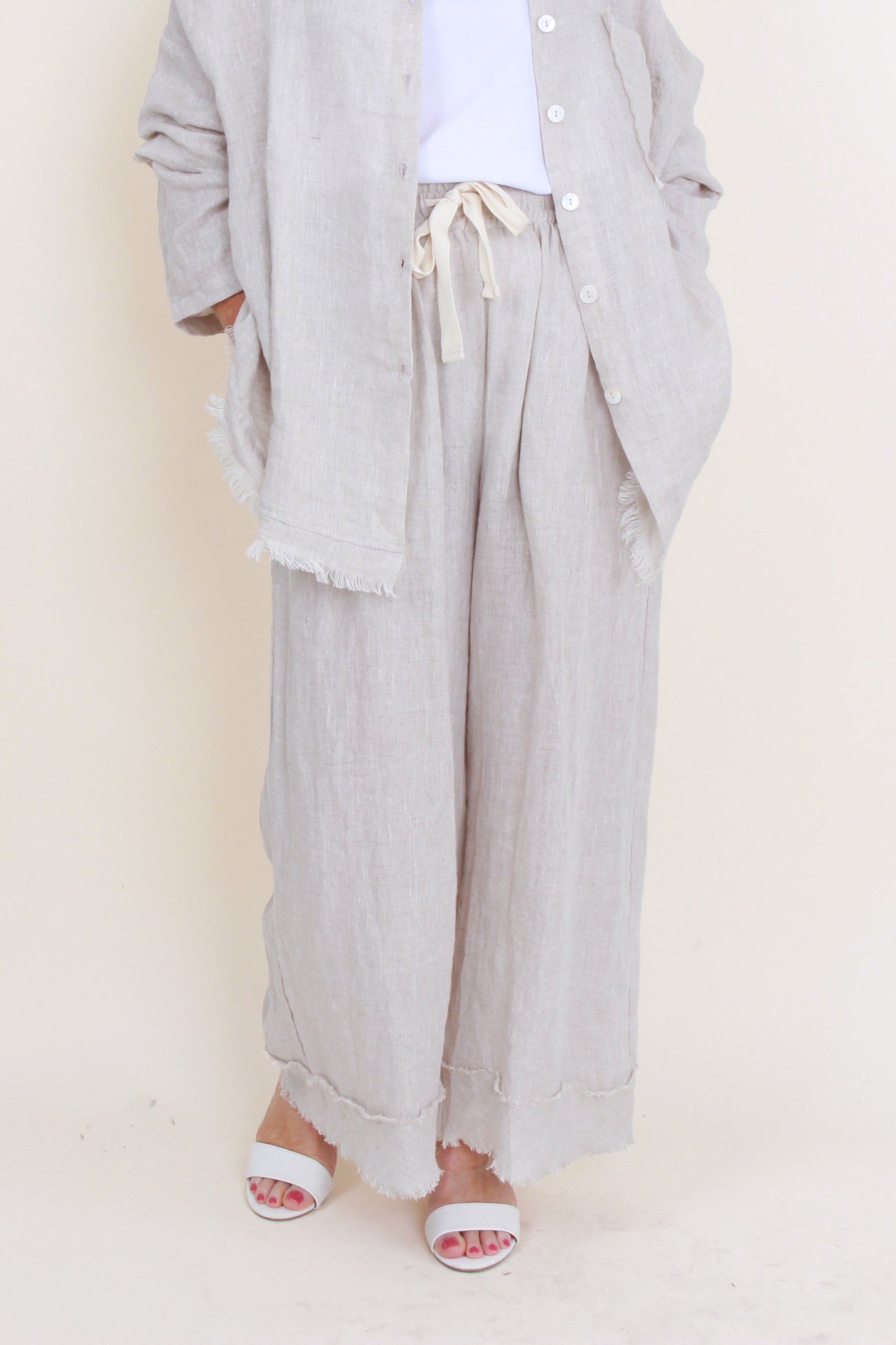 womens relaxed wide leg pants with frayed hem colour sand on model 
