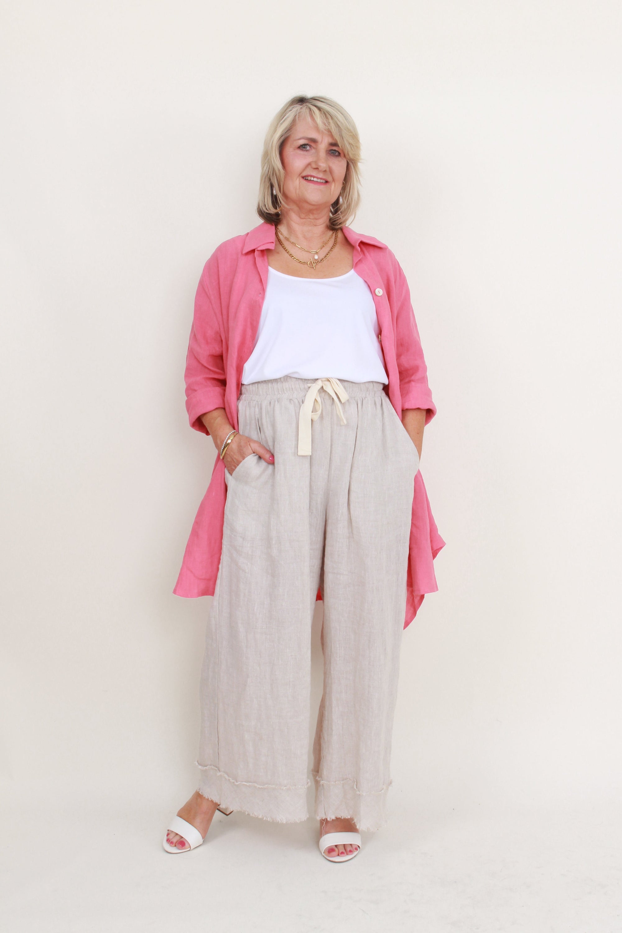 womens high low swing button through top in melon worn by model unbuttoned