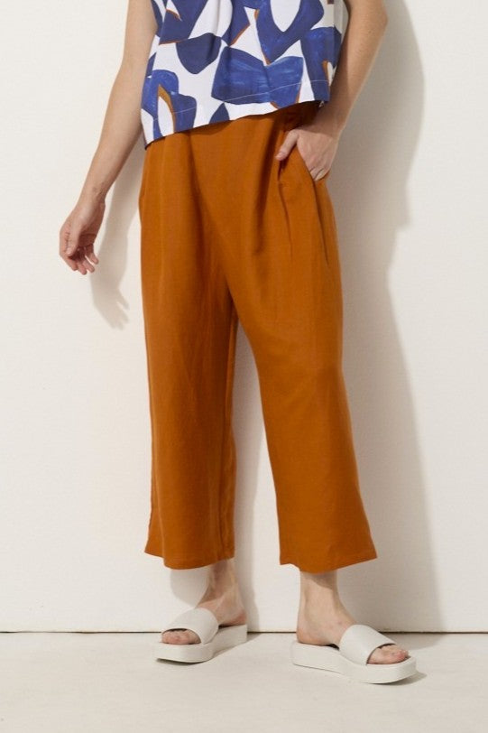 relaxed fit linen blend pant in rust worn by model 