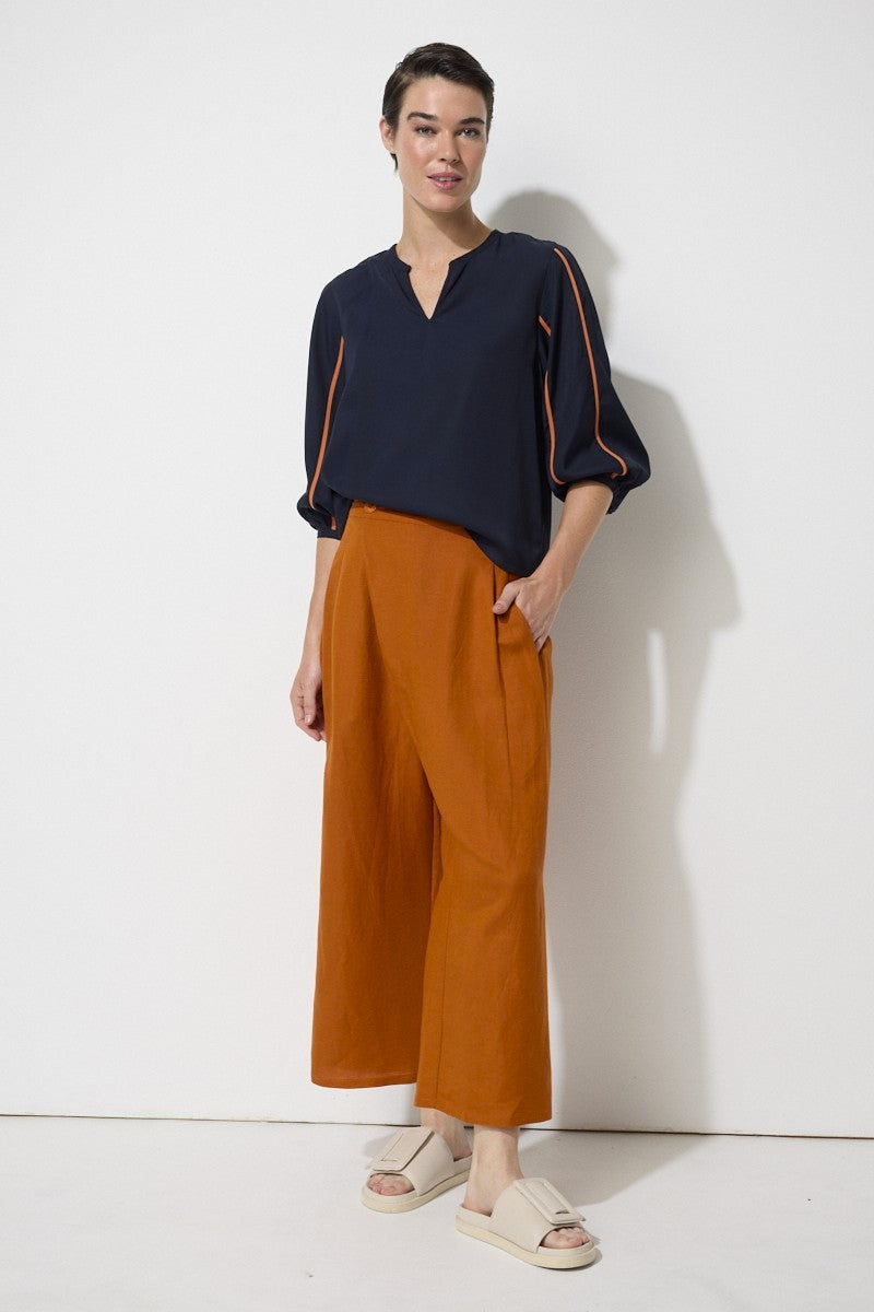 relaxed fit linen blend pant in rust worn by model 