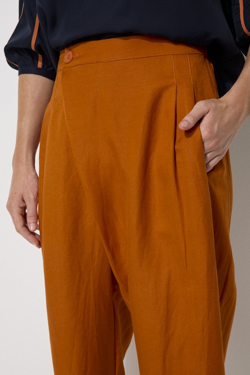 relaxed fit linen blend pant in rust worn by model close up