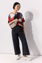Model wearing an abstract print tee shirt against a white background
