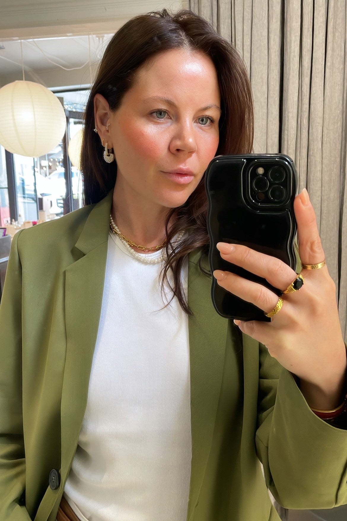 gold heart charm hoop earrings with pearl details on ear