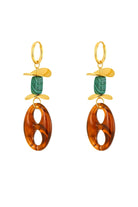 A pair of gold drop earrings featuring a small green stone bead, a gold leaf-shaped charm, and a large amber oval drop, shown on a plain white background.