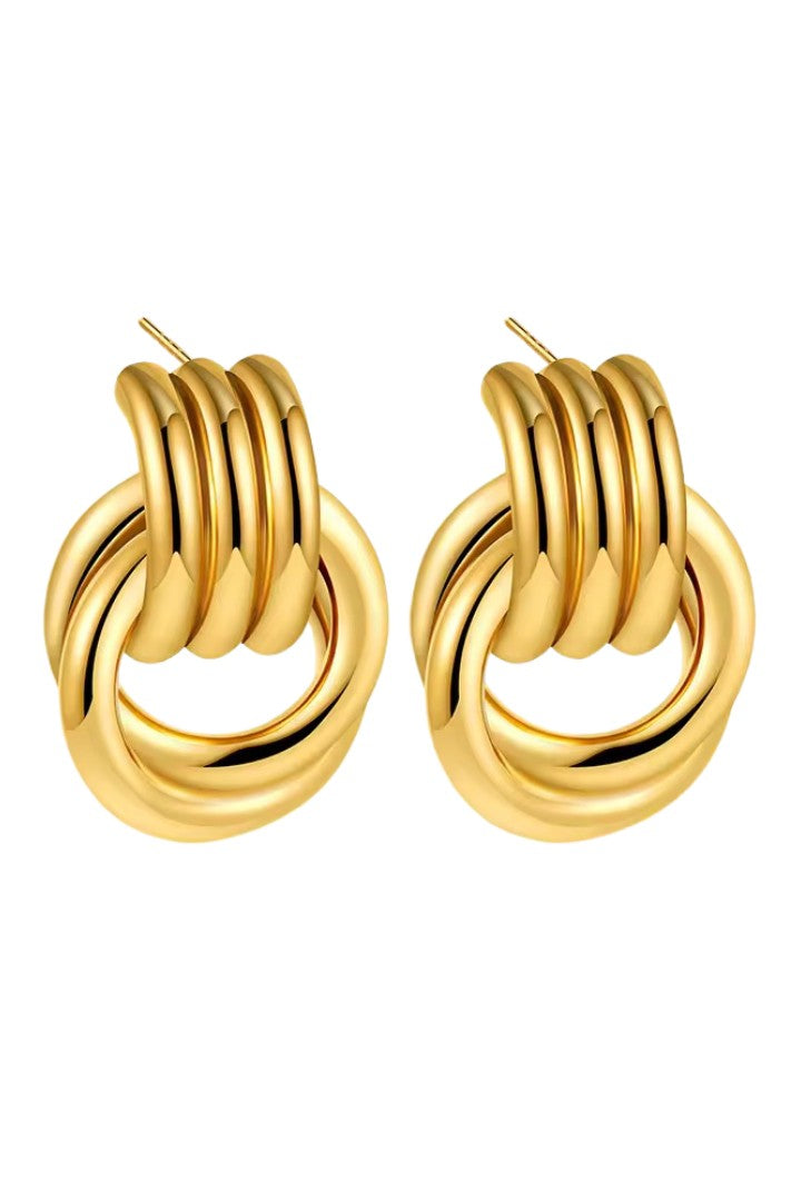 Gold loop drop hoop earrings on a white background