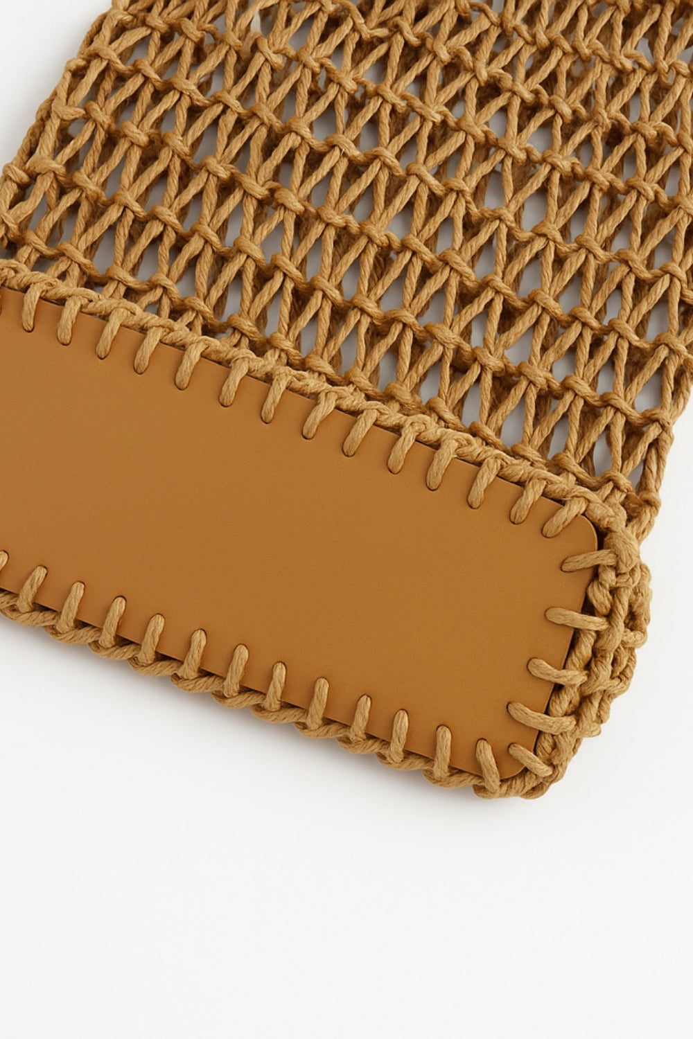 Close-up of a brown woven pouch with a plain background