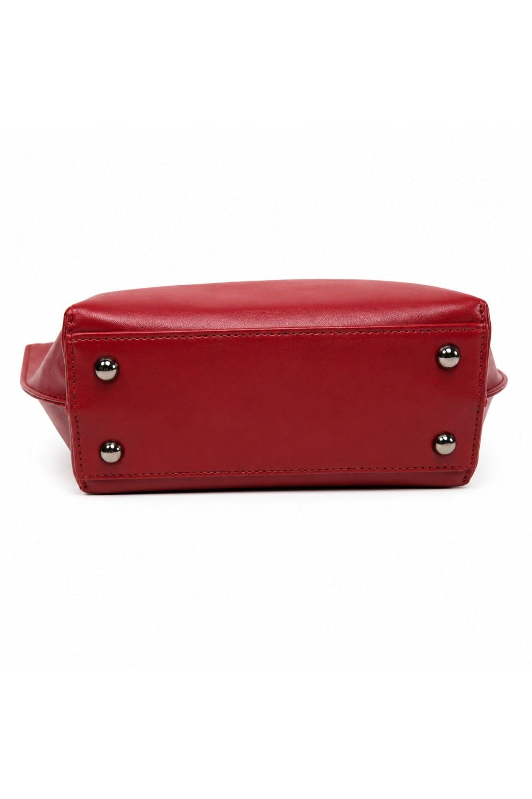 The bottom view of a red leather handbag showing the base with four silver-tone metal studs, set against a plain white background.