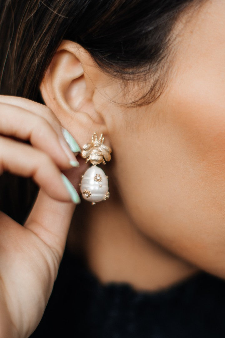 pearl and gold bee drop earrings on ear