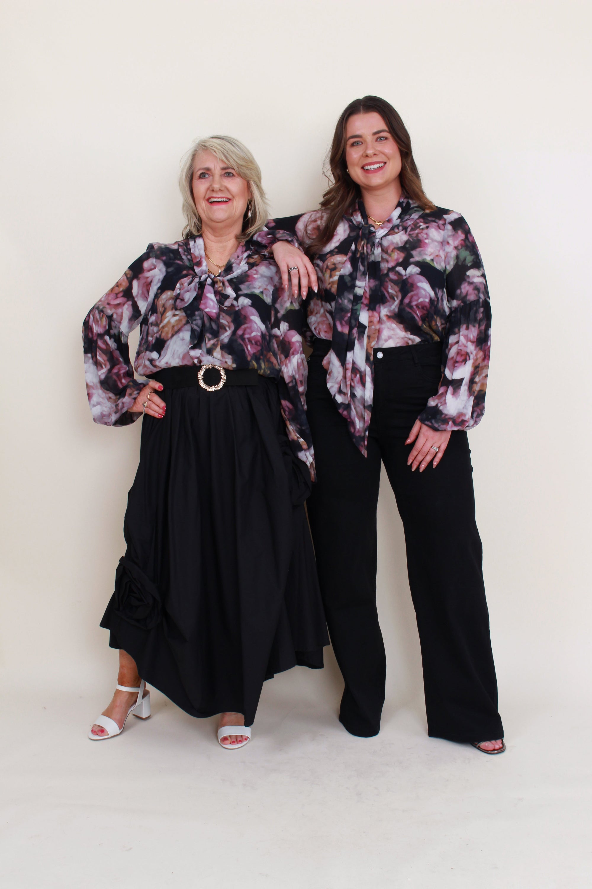 womens floral blouse with neck tie worn by 2 models