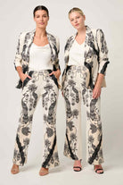 womens cream with black linework print blazer and pant worn by two models