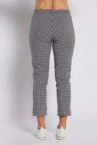 Black and white gingham cropped pants shown from the back on a model, paired with white sneakers against a light gray studio background.