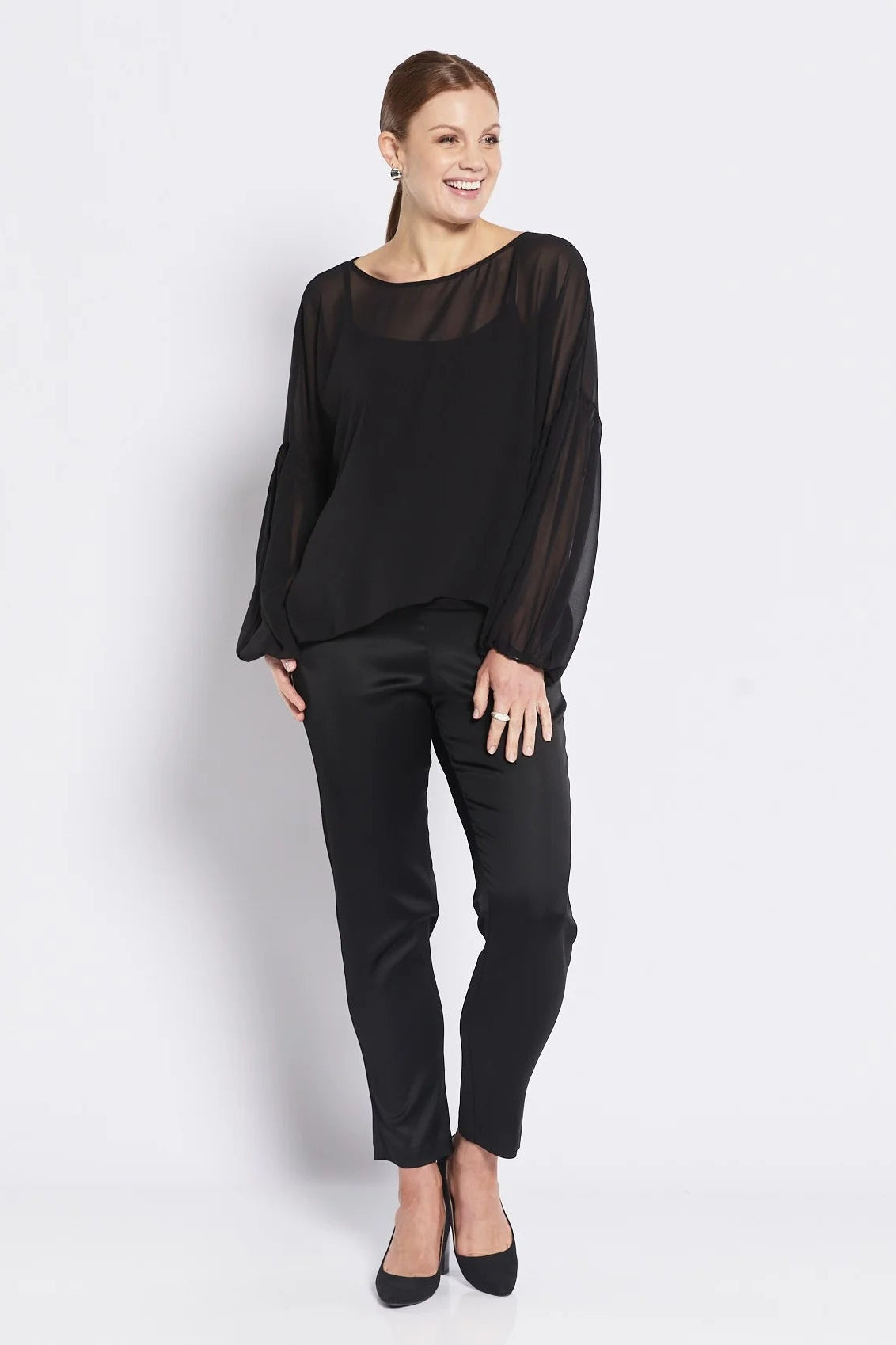 Woman wearing a black outfit on a white background