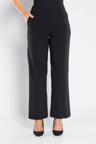 Black pants worn by a person on a white background