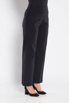 Black pants worn by a person on a white background