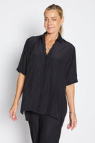 Woman wearing a black shirt and pants on a white background