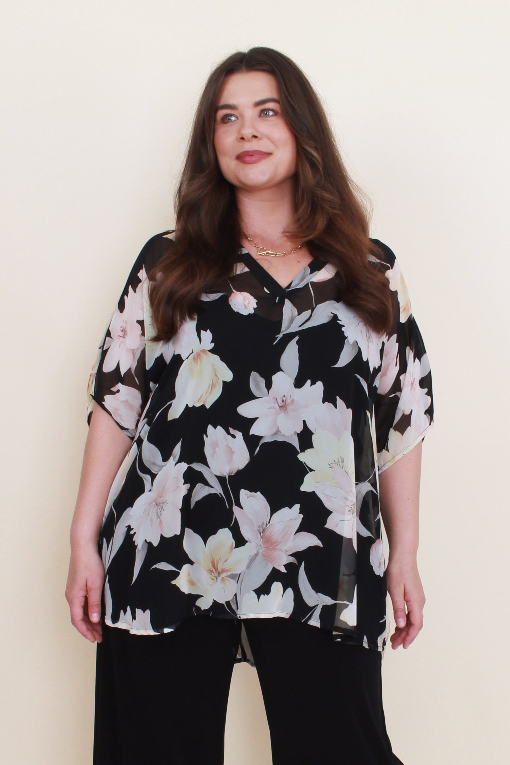 black with light floral chiffon blouse worn by model