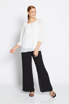womens chiffon overlay wide leg pants black with white blouse worn by model 