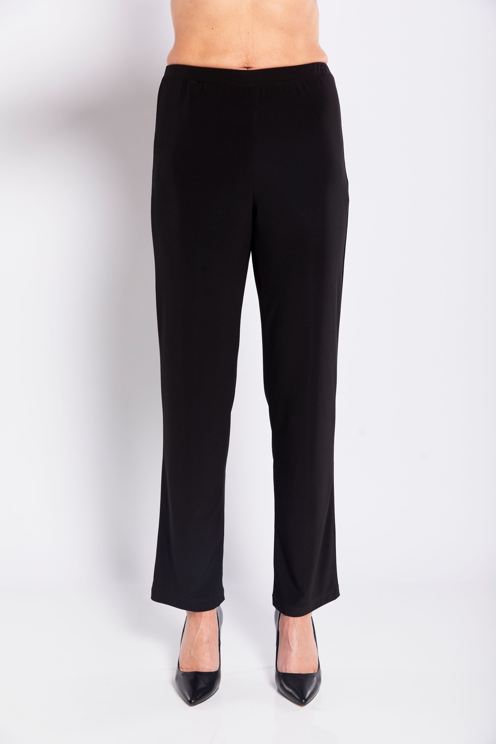 Black pants worn by a person on a white background