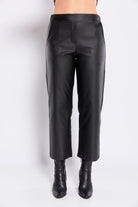 Black leather pants worn by a person on a white background