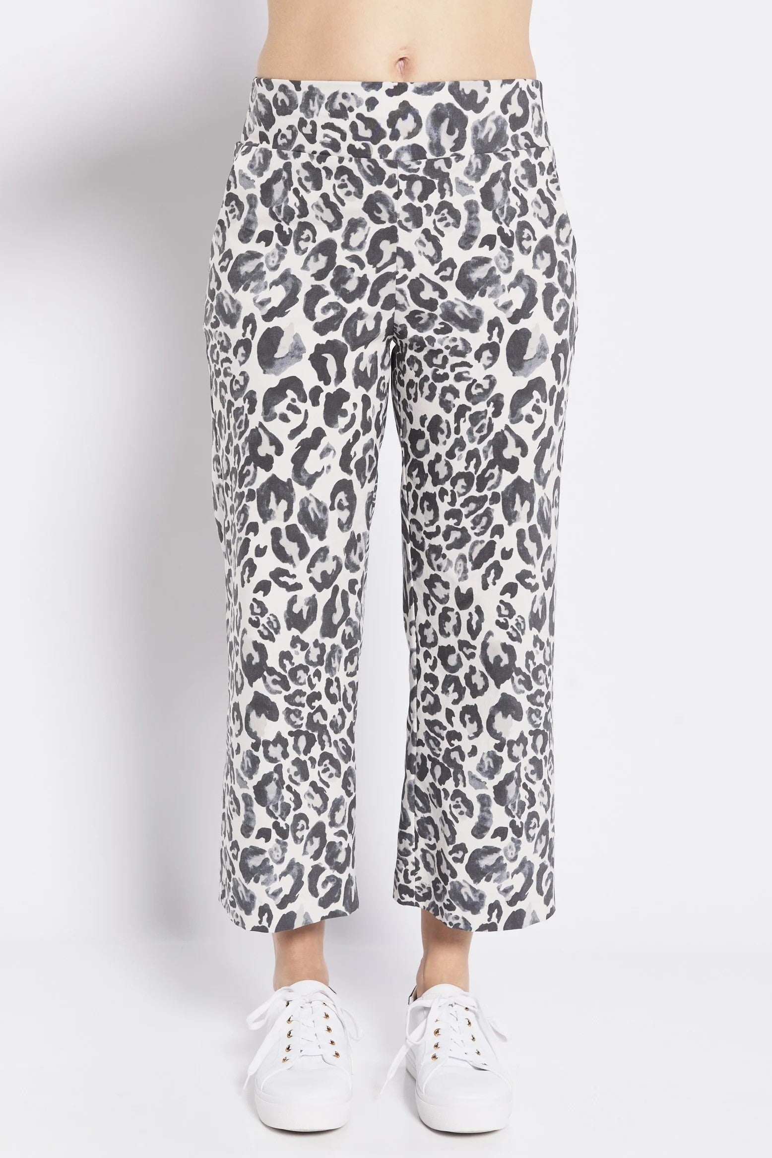 Grey leopard print pants worn by a person on a white background
