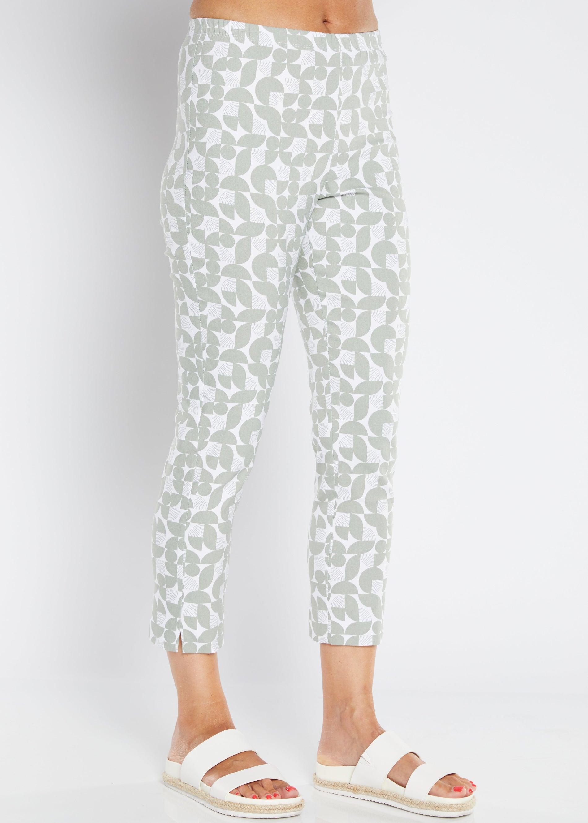 White pants with a subtle greenpattern worn by a person on a white background