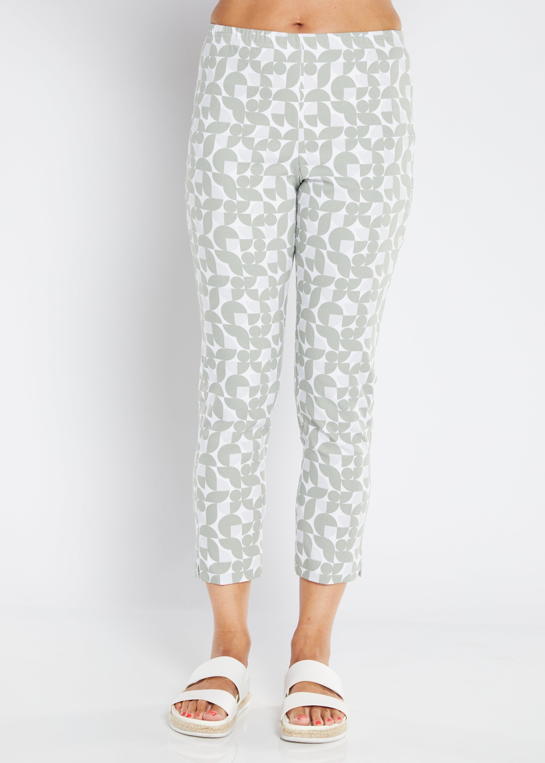 White pants with a subtle pattern worn by a person on a white background