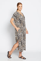 Woman wearing a leopard print dress on a white background