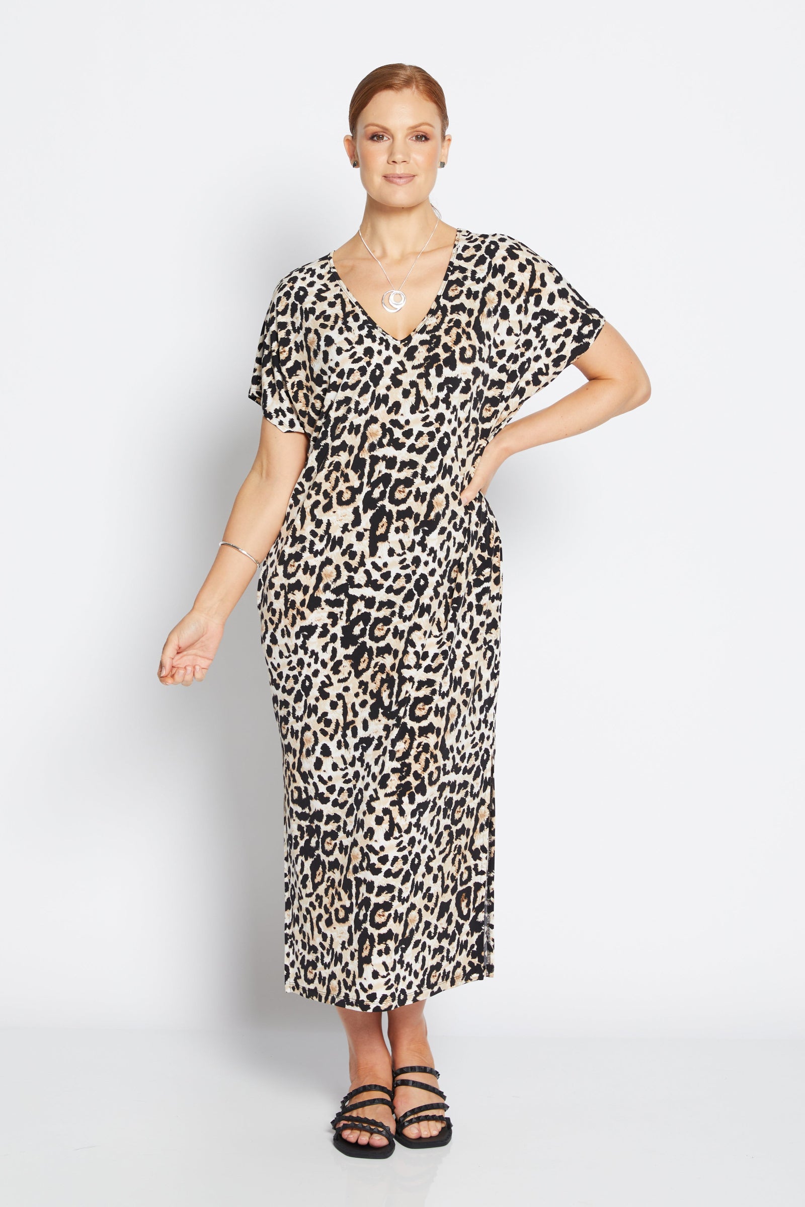 Woman wearing a leopard print dress on a white background